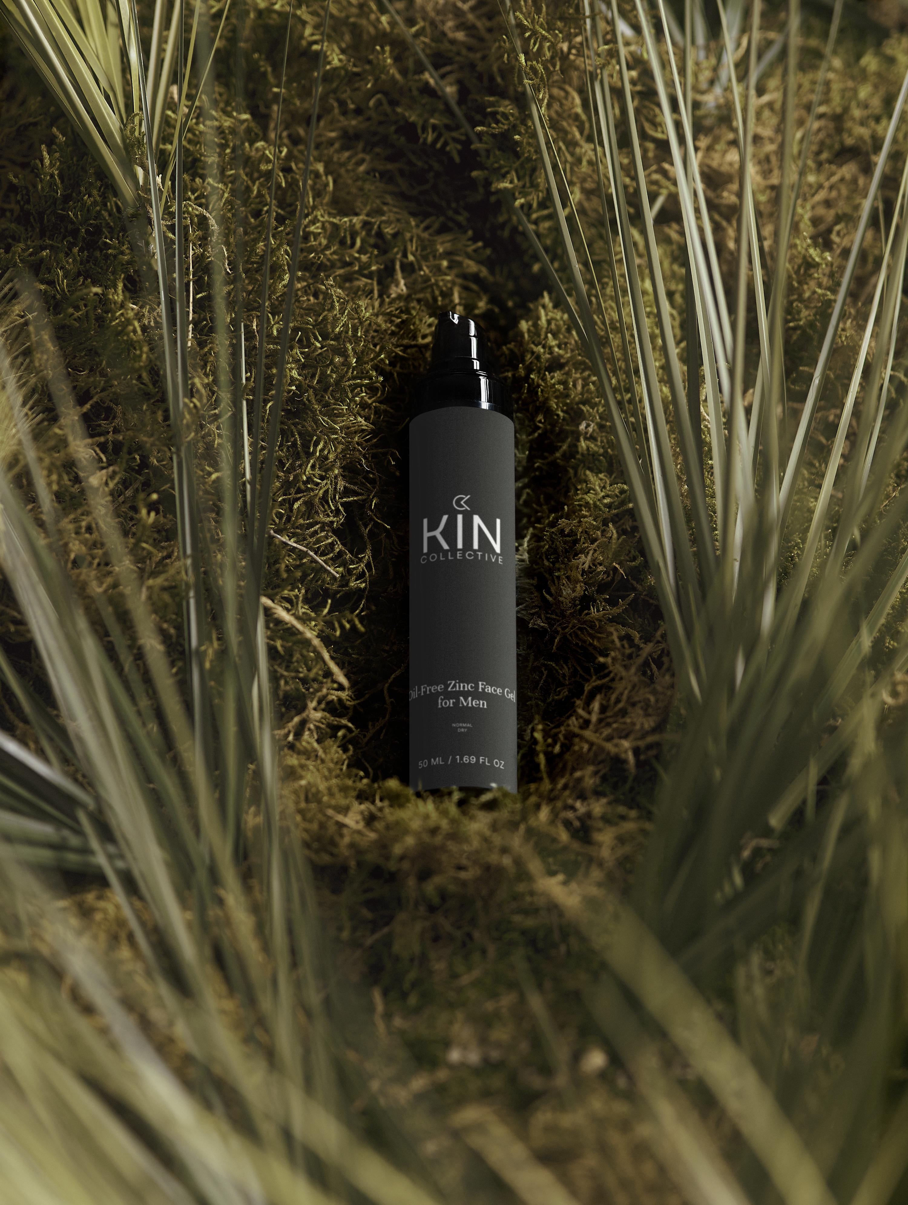 Zinc face gel for men in black bottle displayed outdoors on green moss with palm leaves