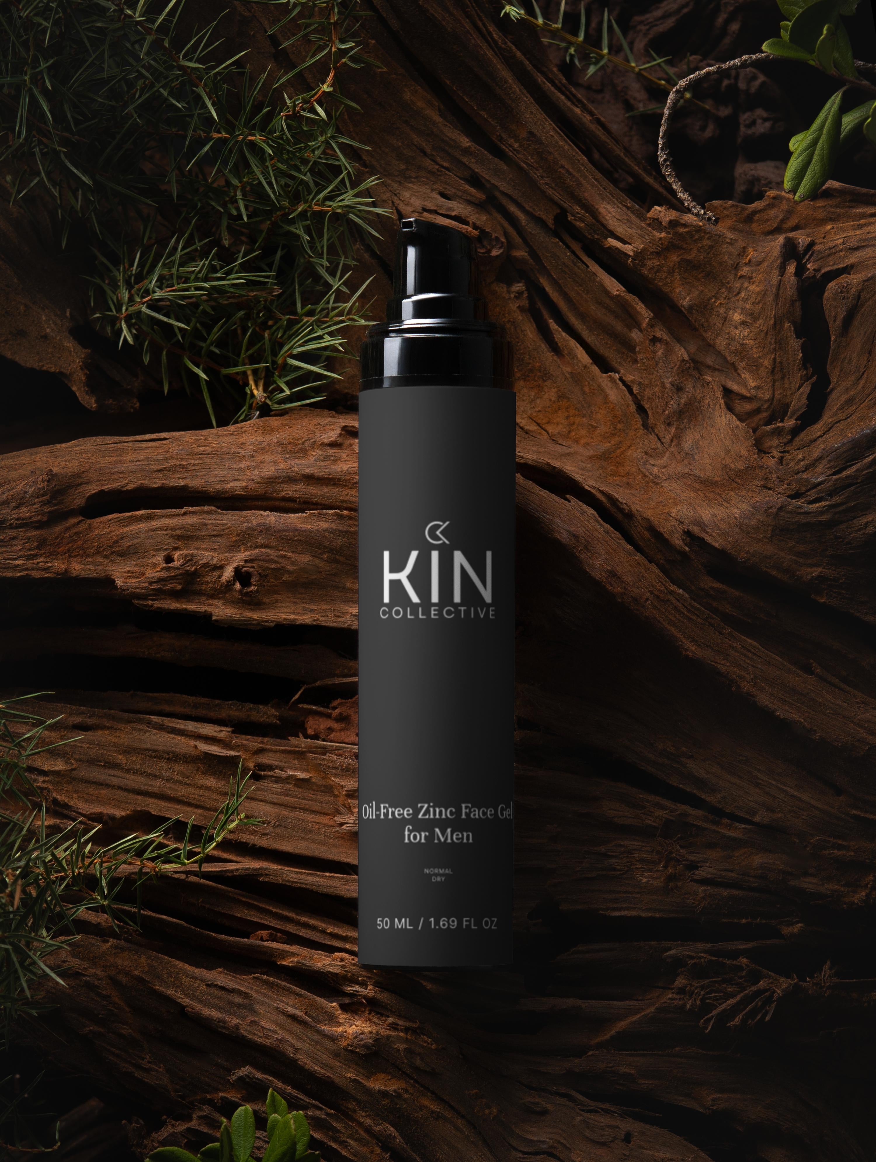 Oil-Free Zinc Face Gel for men in a black pump bottle on dark wood with green foliage