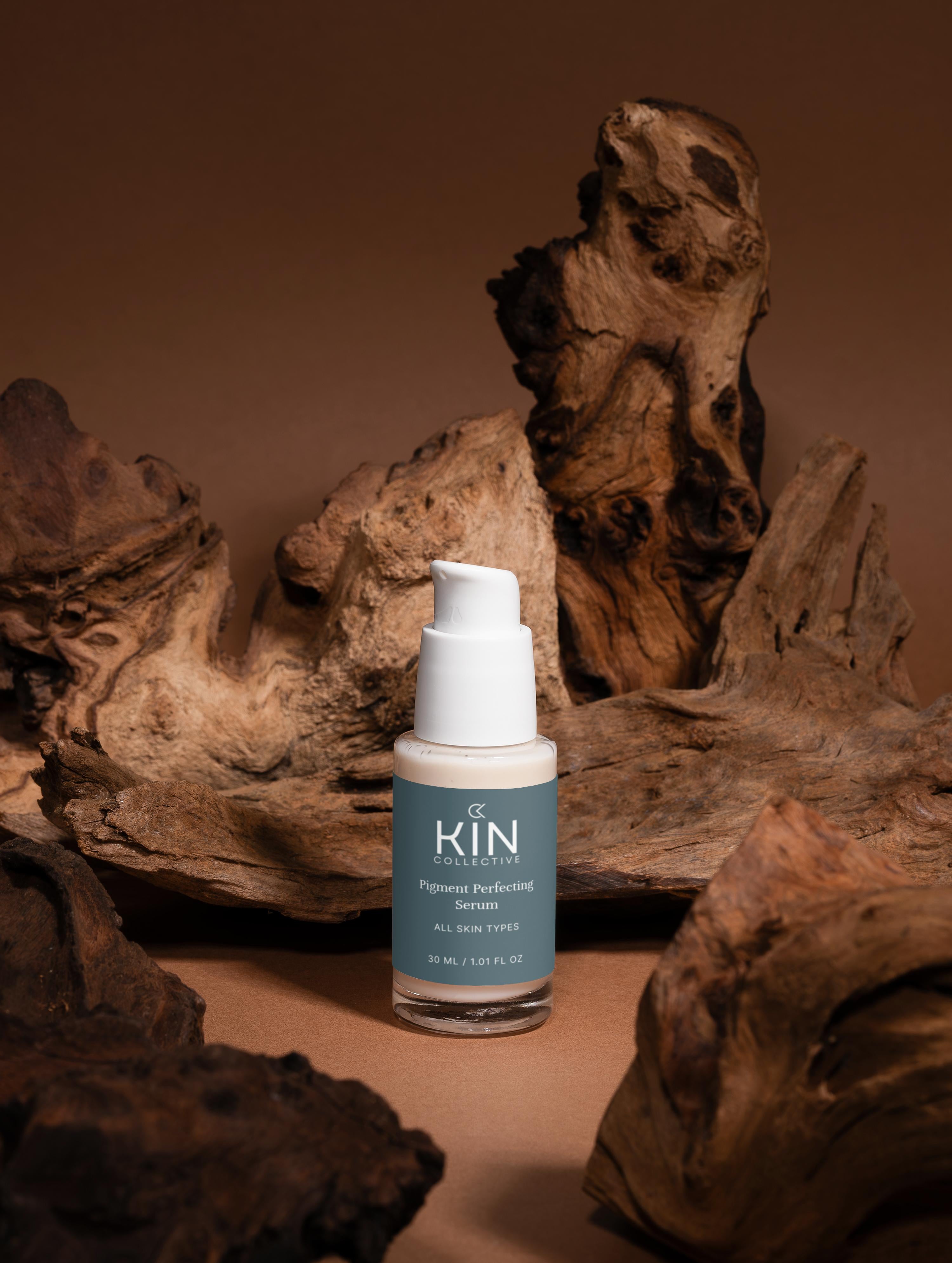 Pigment Perfecting Serum for all skin types on earthy wood background, gentle skincare product