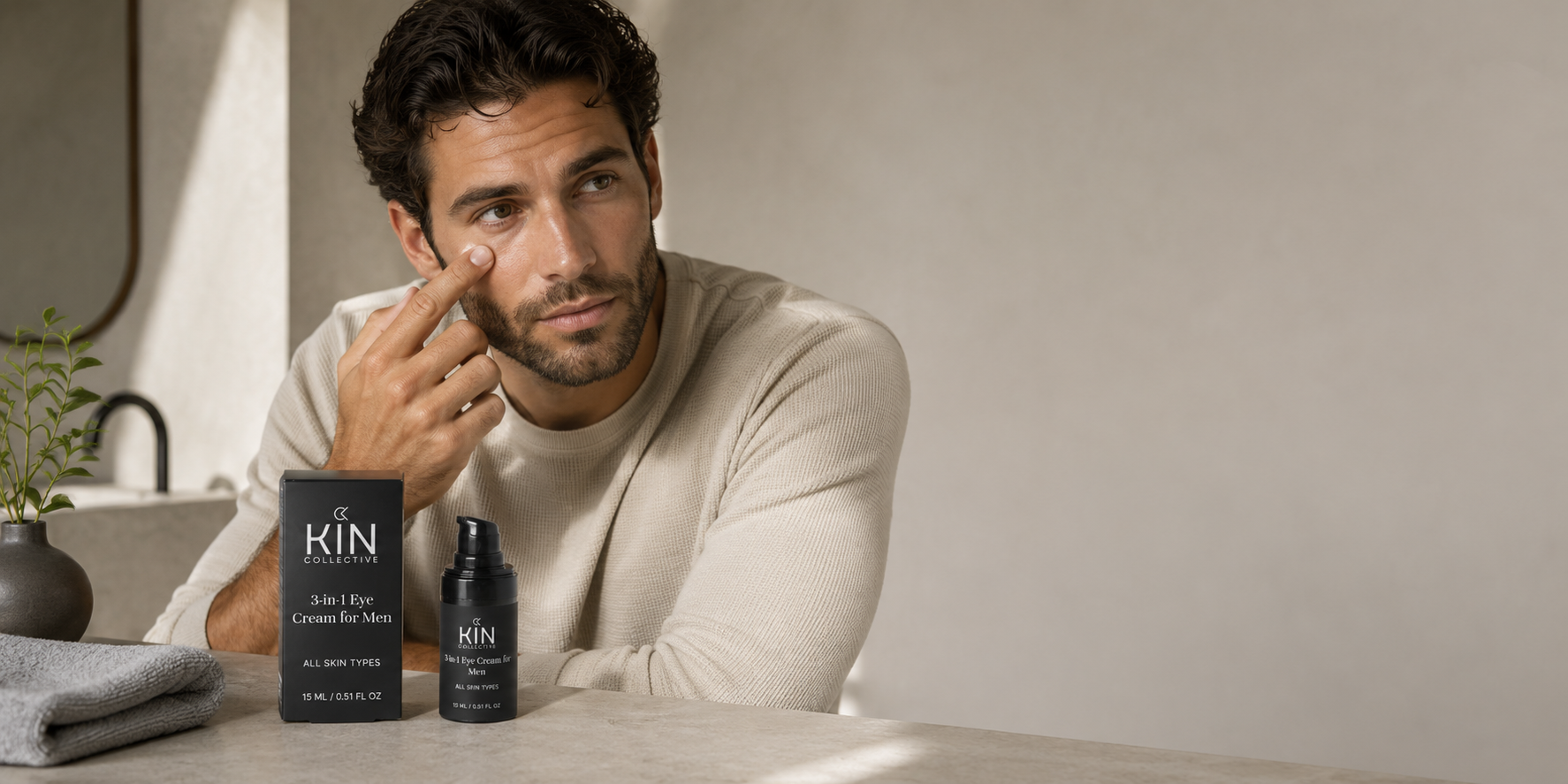 A happy person holding Kin Collective men's skincare