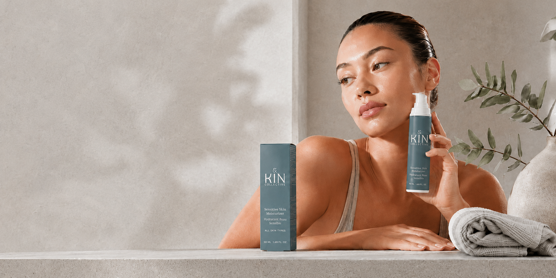 A happy person holding Kin Collective sensitive skincare