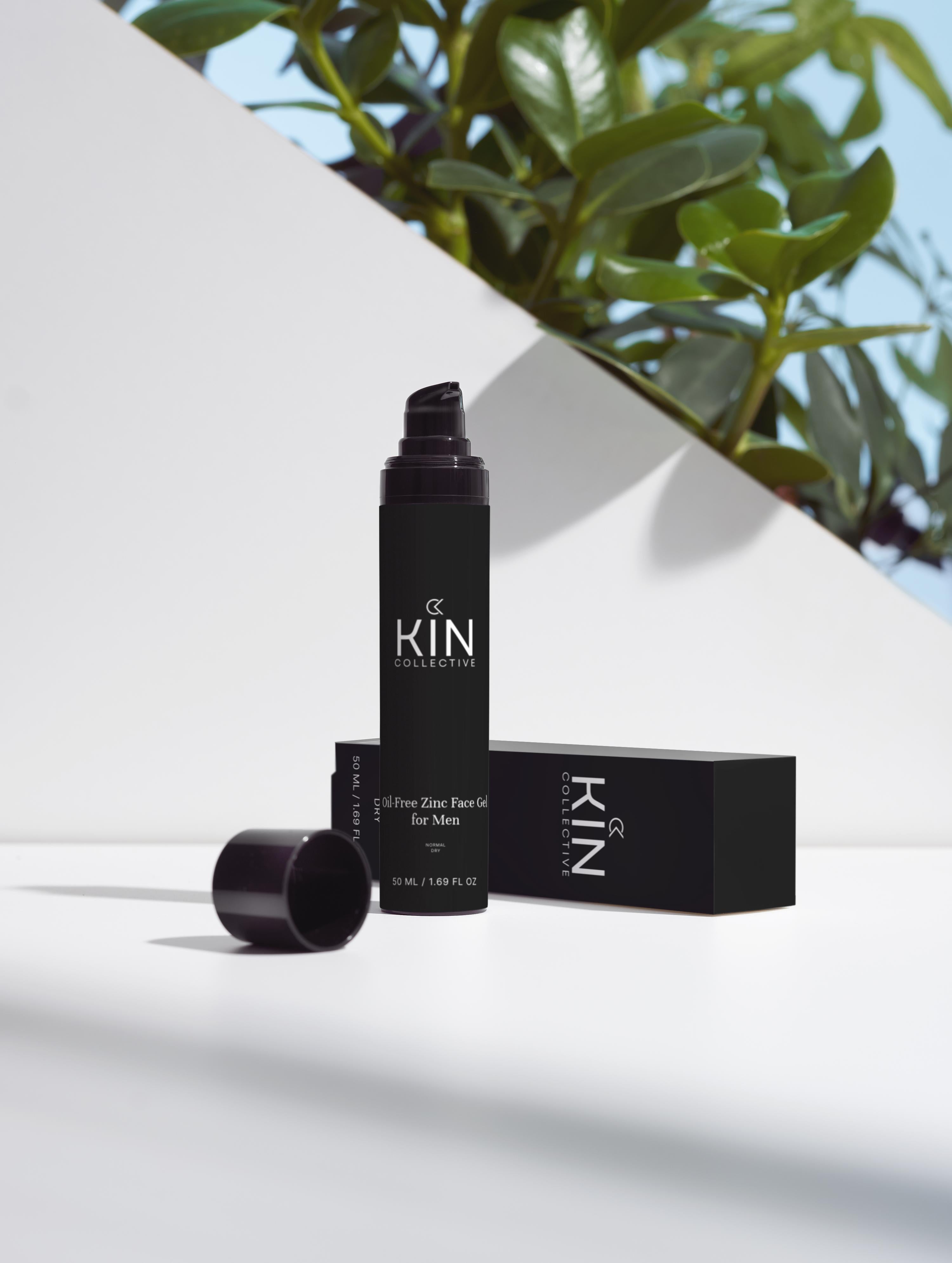 Oil-free zinc face gel for men in black bottle, minimal background, green leaves