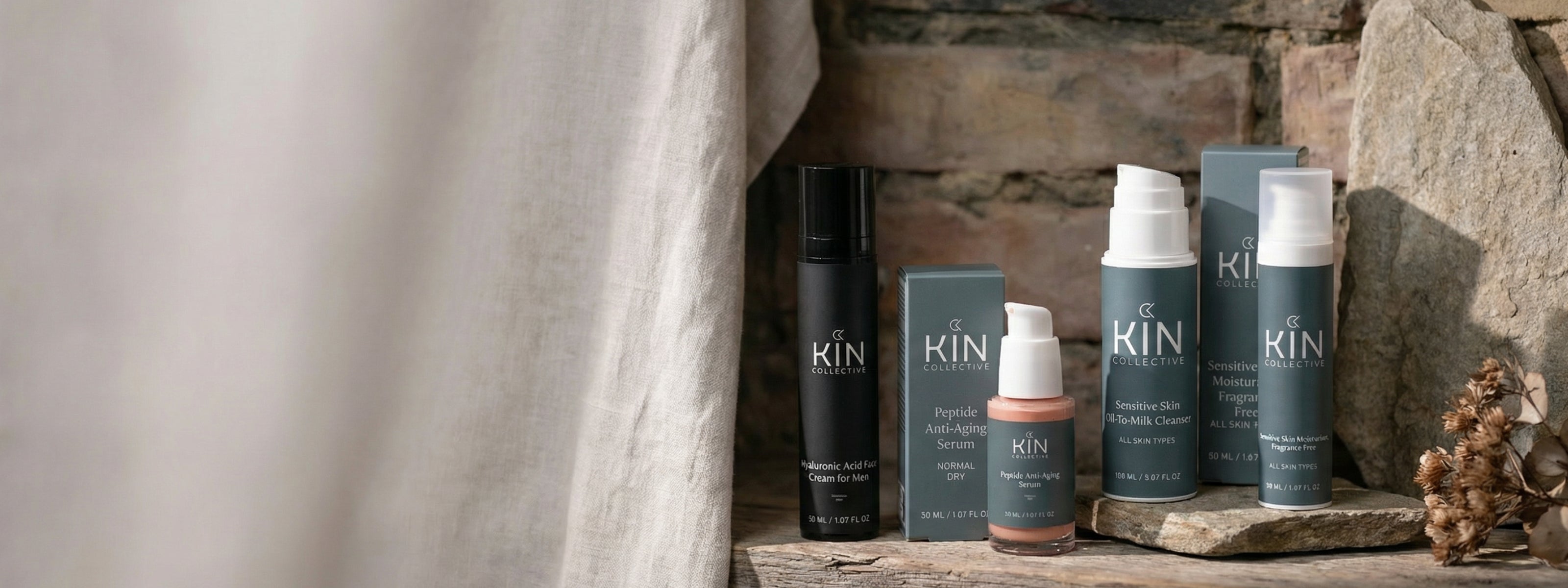 Kin Collective skincare products for sensitive skin and men, displayed on stone with natural lighting