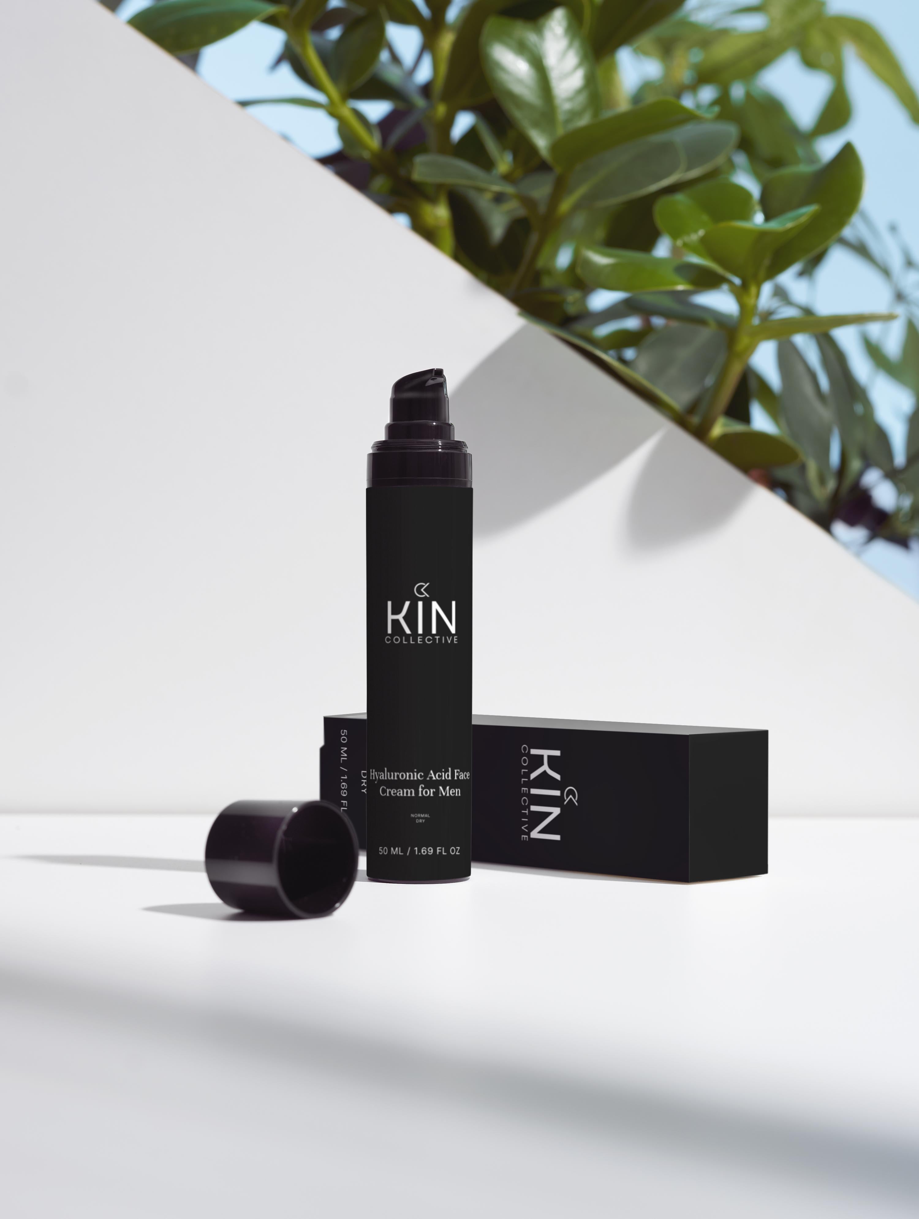Hyaluronic acid face cream for men in black bottle with cap and box, minimal natural light setting