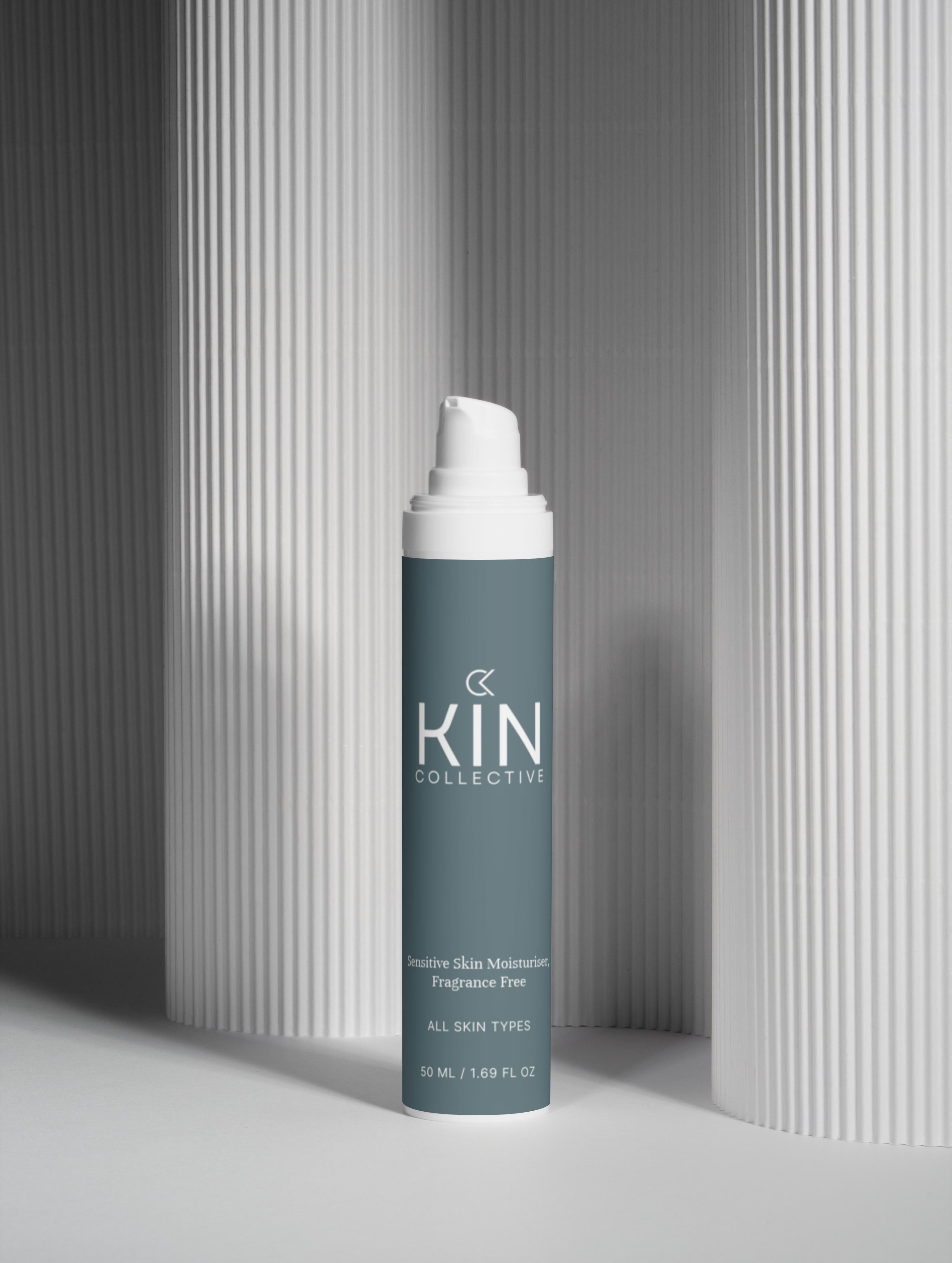 Sensitive skin moisturizer bottle for all skin types, fragrance free, against textured white background.